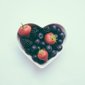 heart-shaped bowl with strawberries